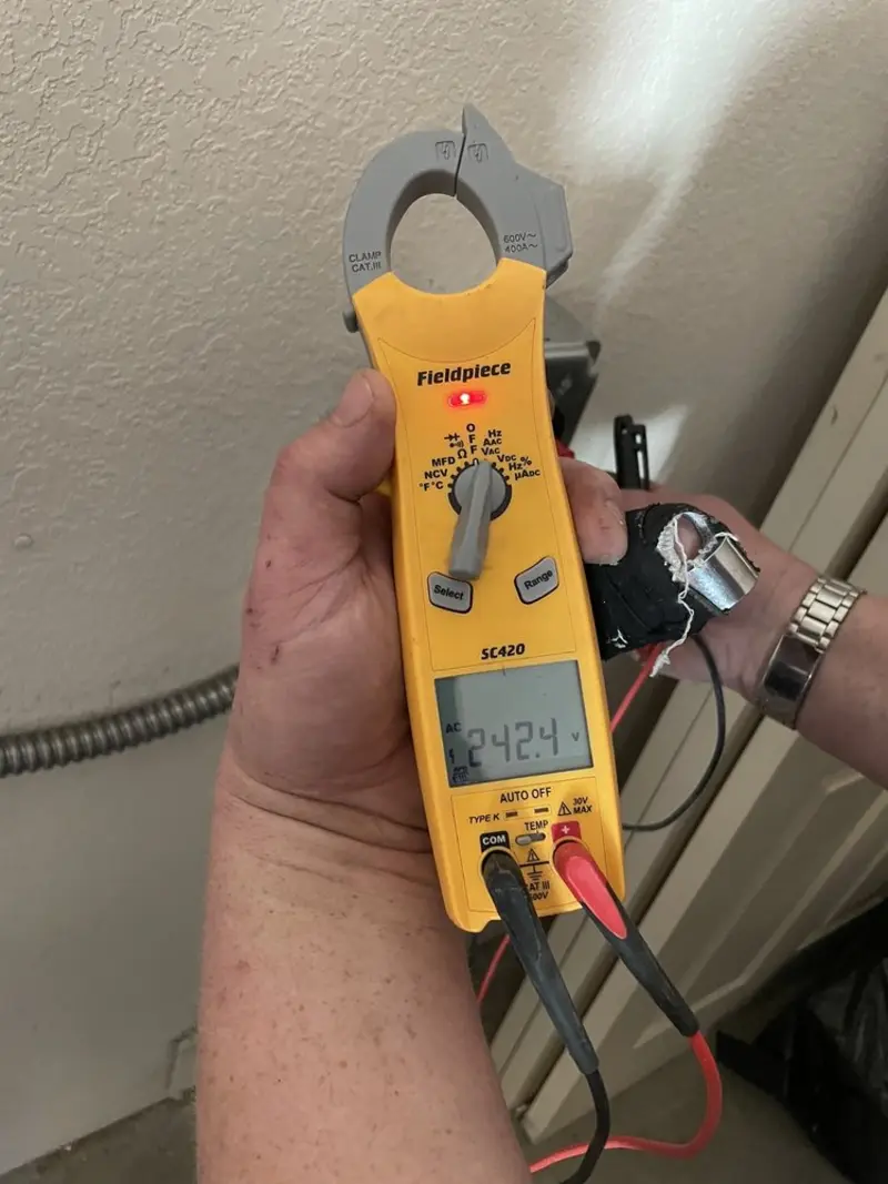 Voltage testing with clamp meter during Electrical Installation Services in Fort Belvoir
